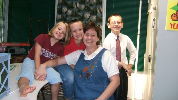 mom and children smiling at the camera