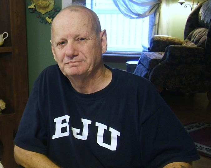 my dad grinning (with food in his mouth, I think)