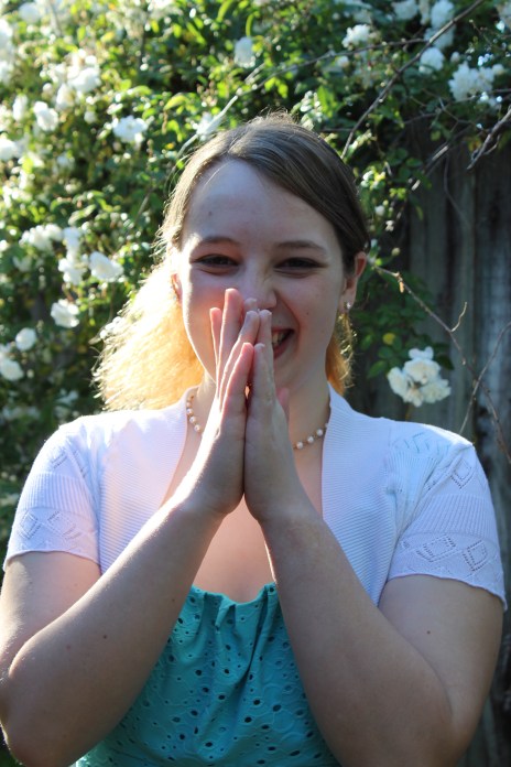 girl laughing, hands in front of her mouth